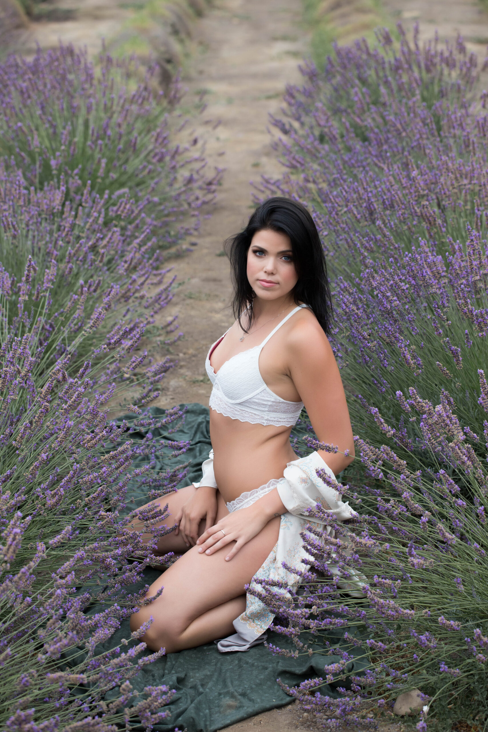 woman sitting in lavender field in intimate clothing