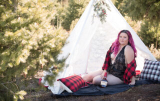 woman sitting in tree farm