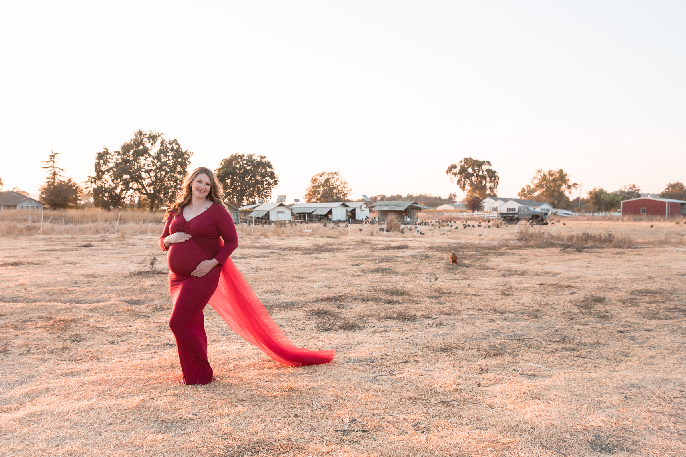 country pregnant woman in red gown