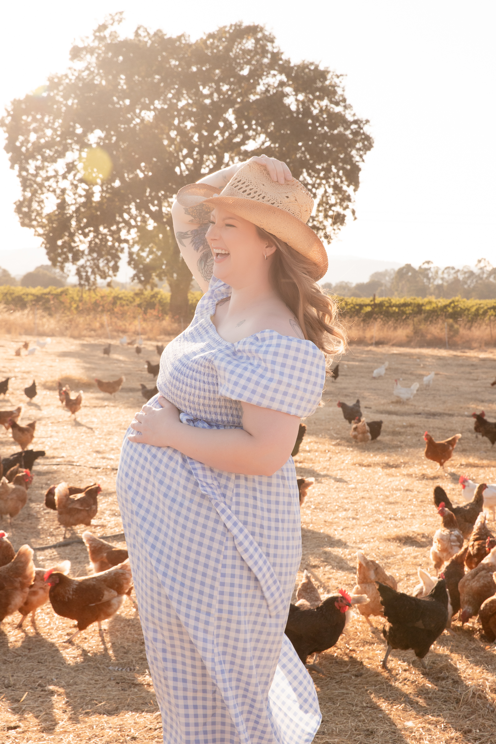 laughing pregnant woman with chickens